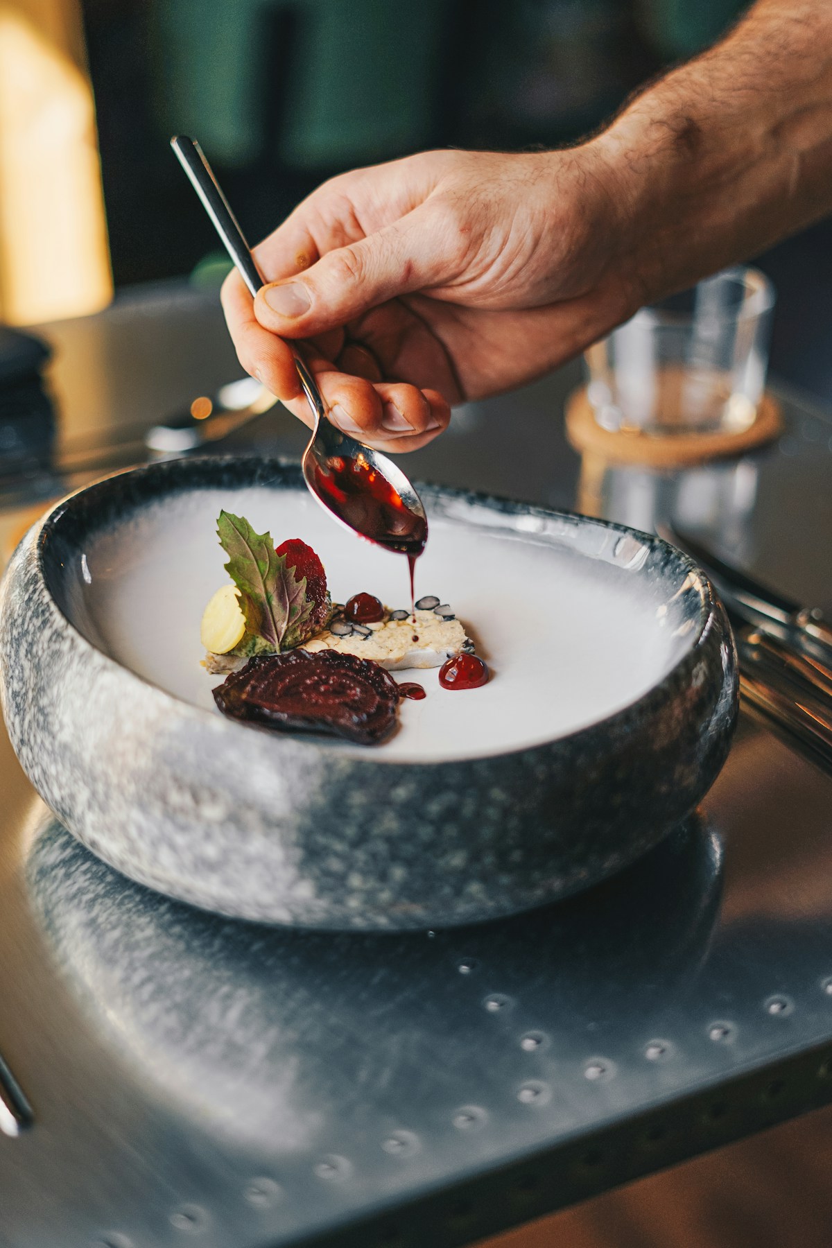 A chef plating a dish with care